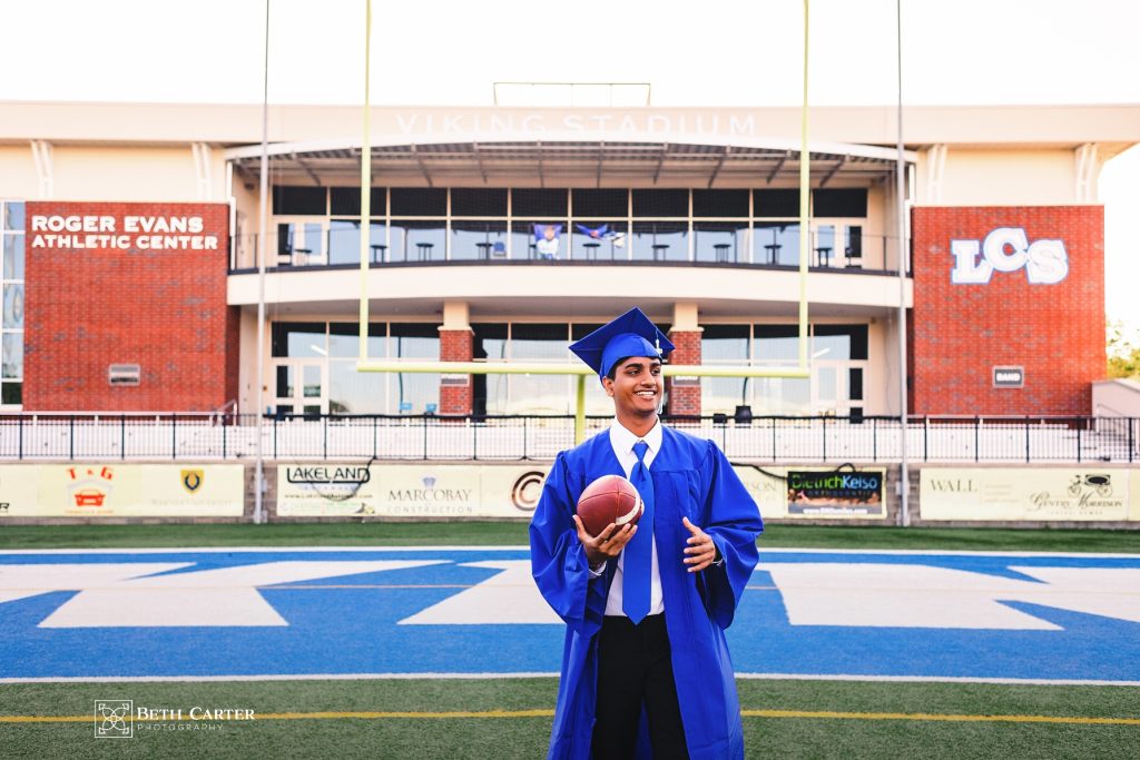 high school senior graduation cap and gown Lakeland Christian School Lakeland, FL - playing football